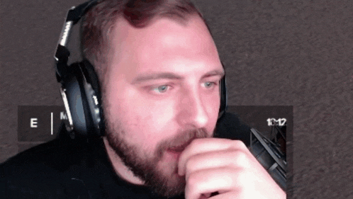 a man with a beard wearing headphones with the letters e and m on them