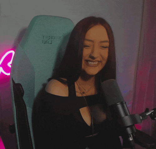 a woman is sitting in a chair with the letter r on it