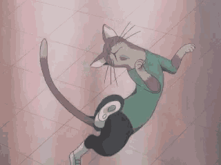 a cat in a green shirt is laying on its back on the floor .