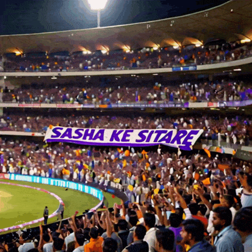 a stadium full of people with a banner that says sasha ke sitare on it