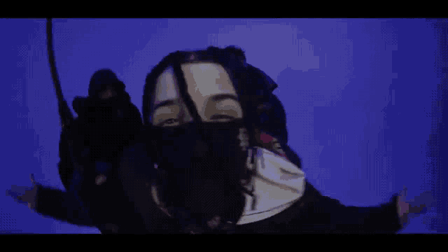 a man with dreadlocks wearing a bandana that says p on it
