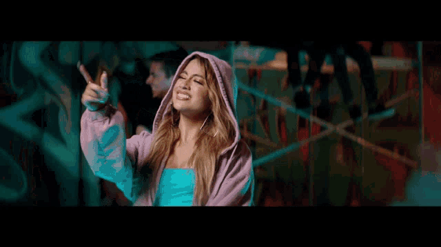 a woman in a purple hoodie is laughing