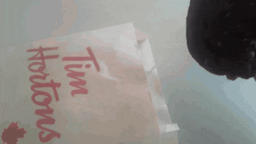 a close up of a tim hortons sign on a table