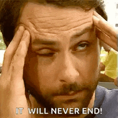 a man with a beard is holding his head while making a funny face .