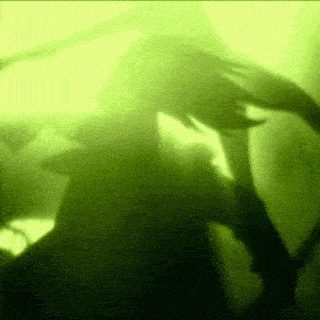a shadow of a person in a green light