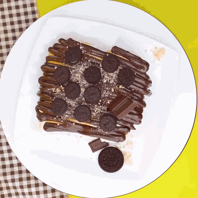 a white plate topped with oreos and chocolate sauce