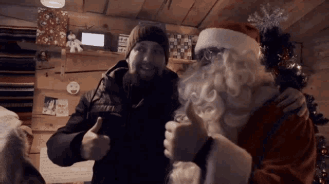 a man is giving a thumbs up to santa claus