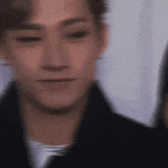 a blurry picture of a young man 's face