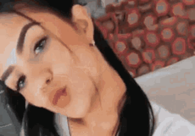 a close up of a woman 's face with a scar on her face taking a selfie .