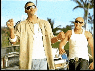 two men are standing next to each other wearing sunglasses