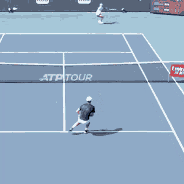two tennis players are playing on a court that says atptour