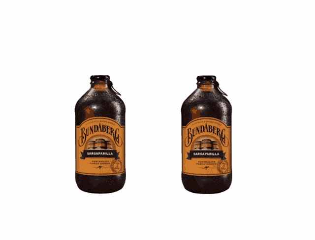 two bottles of bundaberg saraparilla beer are floating in the air