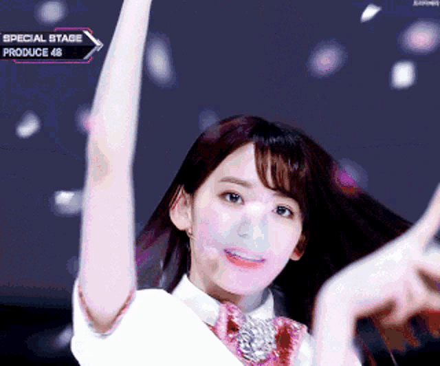 a girl with her arms in the air is on a special stage