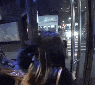 a woman is standing in front of a glass door with a sign on it that says ' a ' on it