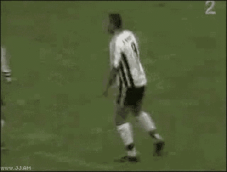 a group of soccer players are dancing on a field .