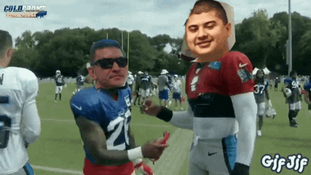a football player with the number 21 on his jersey is talking to another player