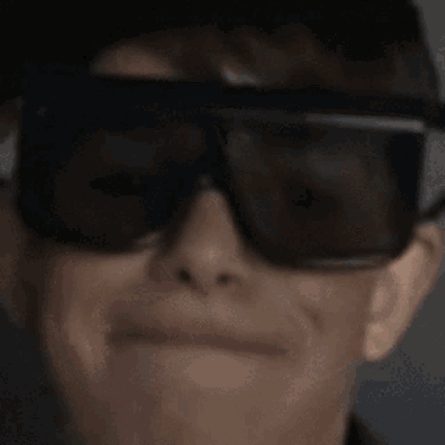 a close up of a person wearing sunglasses .