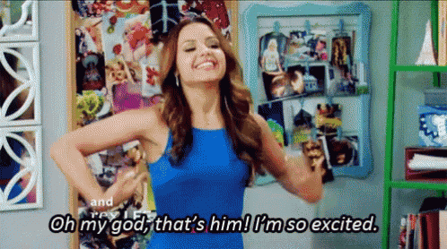 a woman in a blue dress is saying oh my god that 's him ! i 'm so excited