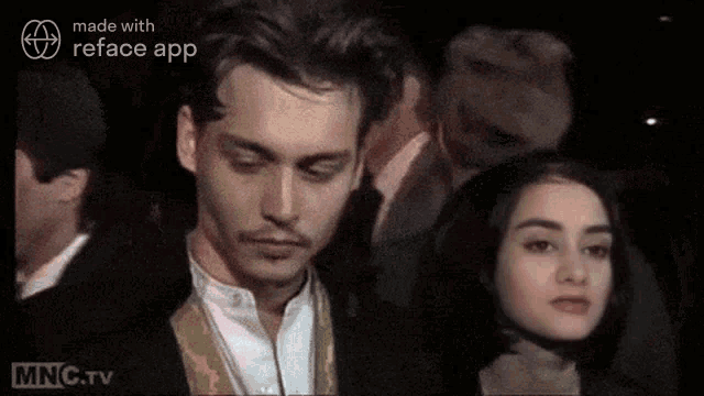 a man and a woman are standing next to each other .