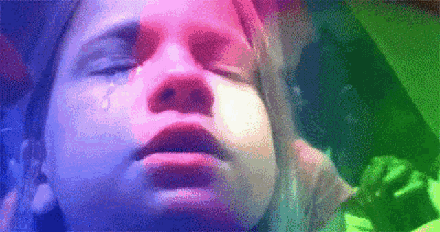 a girl is crying with a tear coming out of her eye