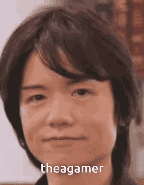 a close up of a man 's face with a caption that says thea gamer