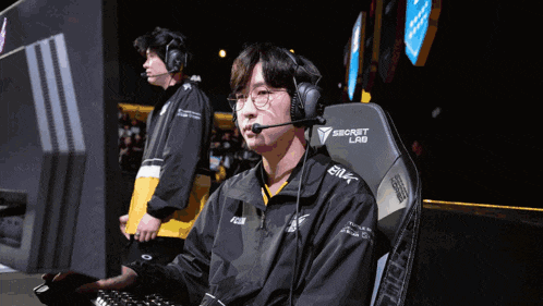 a man wearing headphones is sitting in a chair that says secret lab