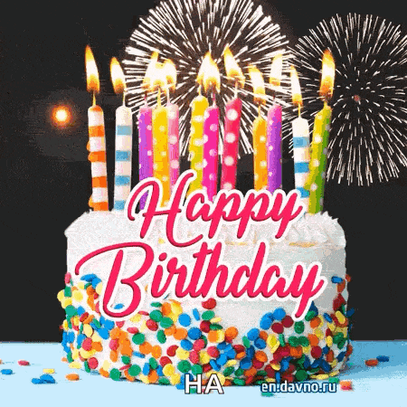 a birthday cake with candles and fireworks behind it .