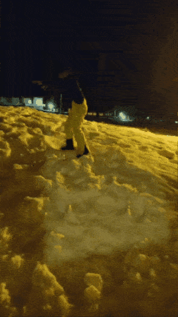 a person in yellow pants is standing in the snow