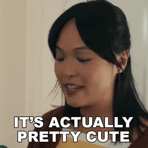 a woman is smiling and saying it 's actually pretty cute .