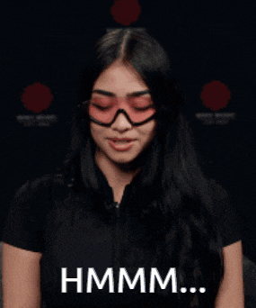 a woman wearing pink sunglasses and a black shirt says hmm