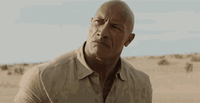 the rock is making a funny face in the desert .
