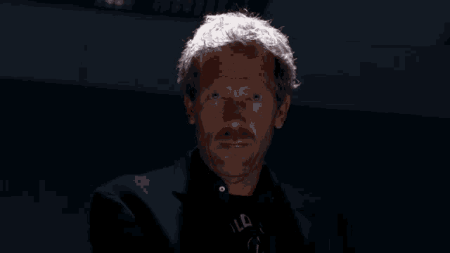 a man with blood on his face is wearing a t-shirt that says old