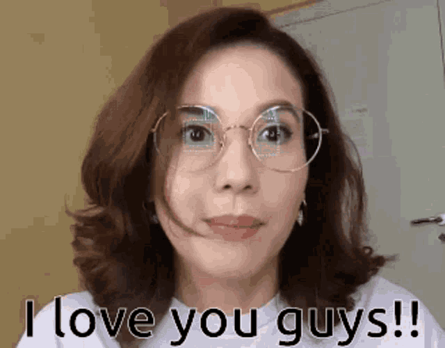 a woman with glasses says i love you guys