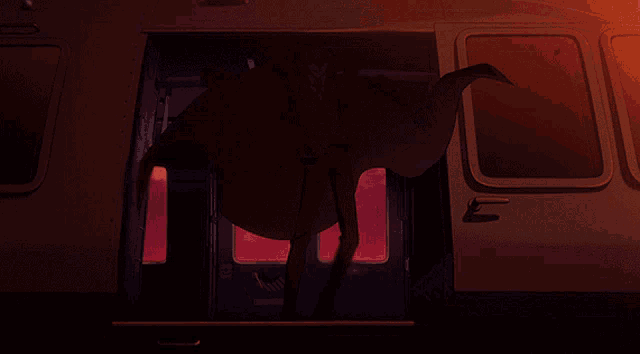 a man in a suit is standing in the doorway of a vehicle