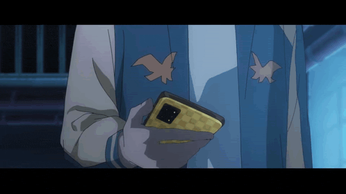 a person in a blue jacket holds a cell phone
