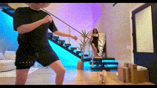 a man and a woman are standing in a living room .