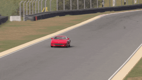 a red sports car is driving down a road in a video game
