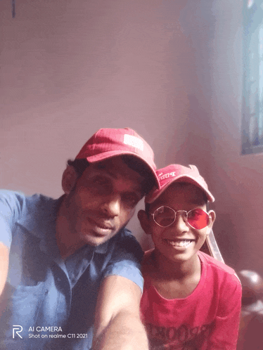 a man and a boy are posing for a picture with the words ai camera shot on realme c11 2021 on the bottom right