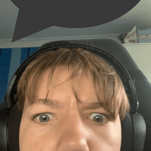 a close up of a person wearing headphones with a speech bubble above their head