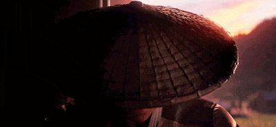 a man wearing a conical hat is looking at the camera