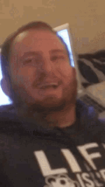 a man with a beard wearing a shirt that says lif