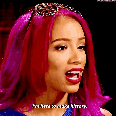 a woman with pink hair is making a funny face and saying i 'm here to make history .