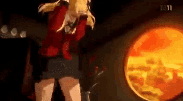 a woman is standing in front of a fire in a dark room .