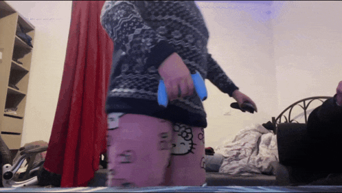 a person wearing a hello kitty sweater and pink socks