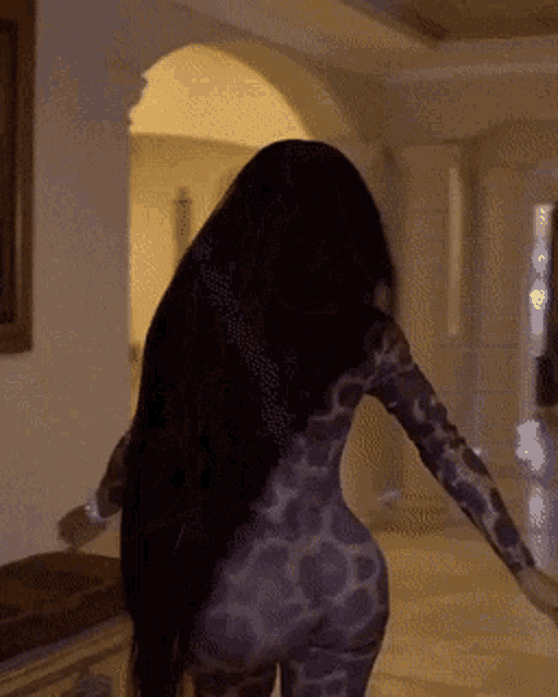 a woman with long black hair is wearing a leopard print outfit