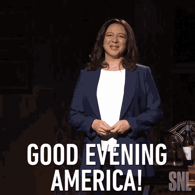 a woman in a blue jacket stands in front of a sign that says good evening america