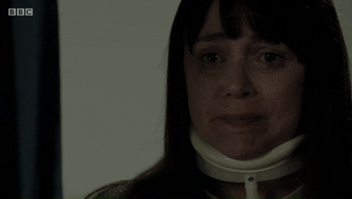 a woman wearing a neck brace is crying on bbc television