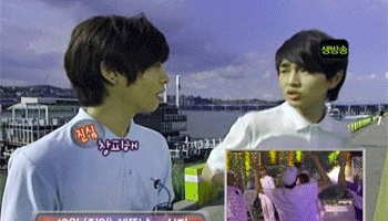 two young men are standing next to each other and one of them has a sticker on his shirt that says ' aoi '