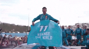 a man is holding up a blue flag that says 11 against the world