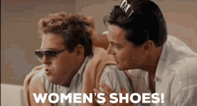 two men are sitting next to each other with the words women 's shoes written on the bottom